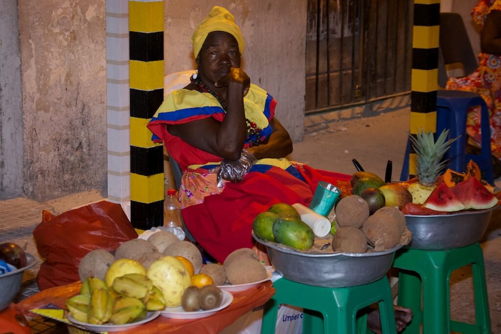 A street vendor wearing the colors of the Colombian flag