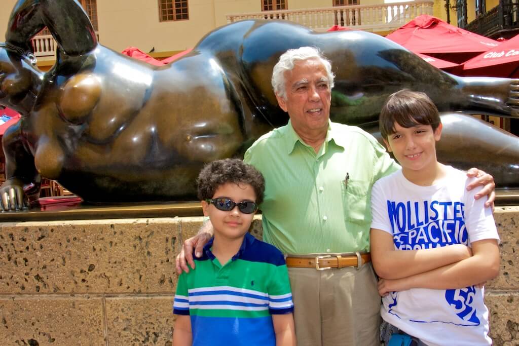 Posing with grandpa and cousin before renowned Colombian painter and sculptor Fernando Botero's "La Gorda"